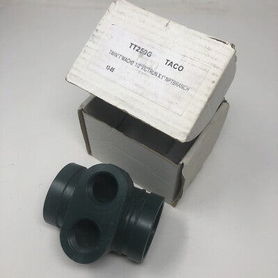 A clear studio product presentation of a Taco LoadMatch Twin-Tee hydronic pipe fitting, showing its solid cast-metal body configuration with dual parallel secondary branch connection ports on top, a thick middle partition casing line, and inline primary run openings over a seamless white background.