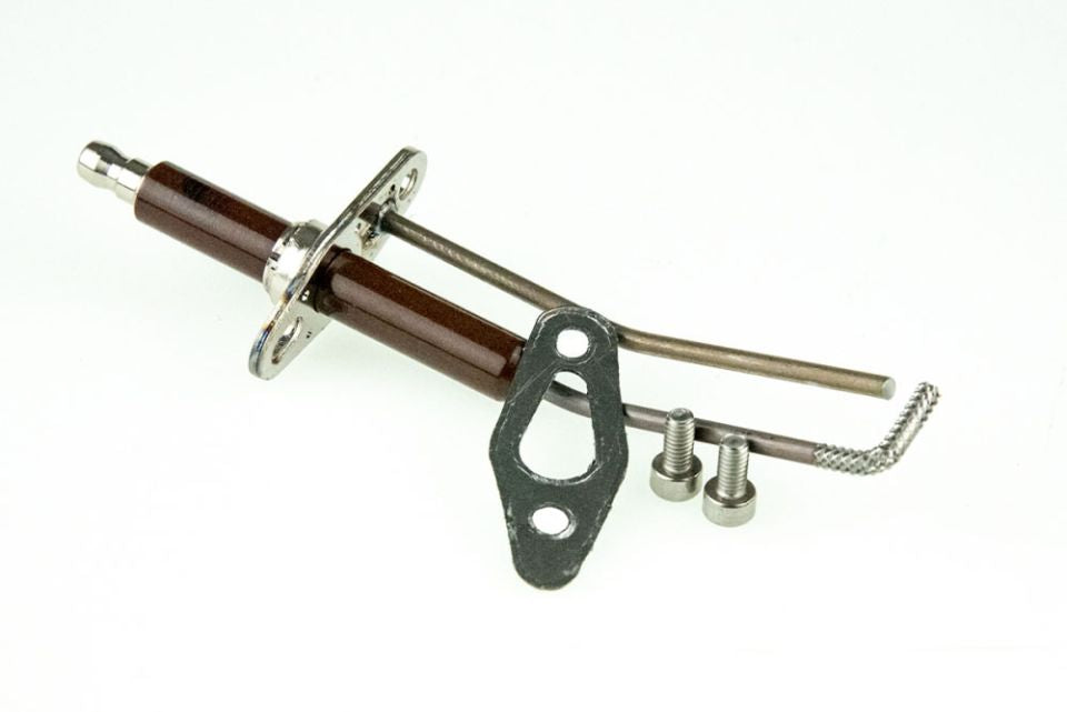 An angled professional studio shot from image_8e821b.jpg of a boiler replacement igniter and sensor rod, highlighting its elongated white glazed ceramic insulator body, a stamped metal mounting flange with an integrated gasket, and bent silver metal electrode probe tips on a solid white background.